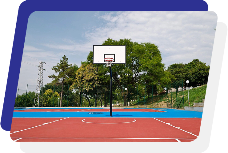 A basketball court with trees in the background.