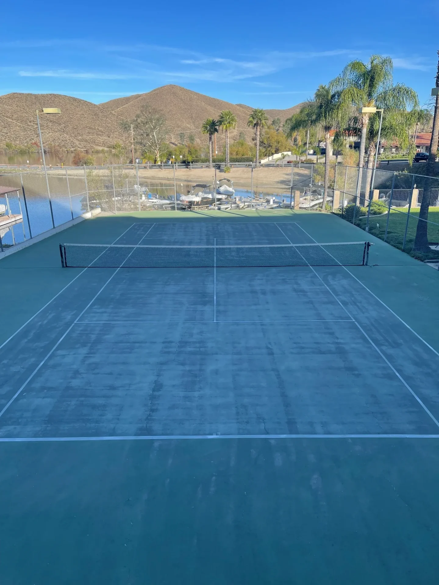 A tennis court with two rackets and one ball