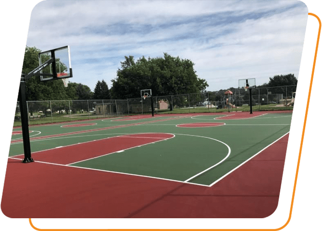 A basketball court with trees in the background.